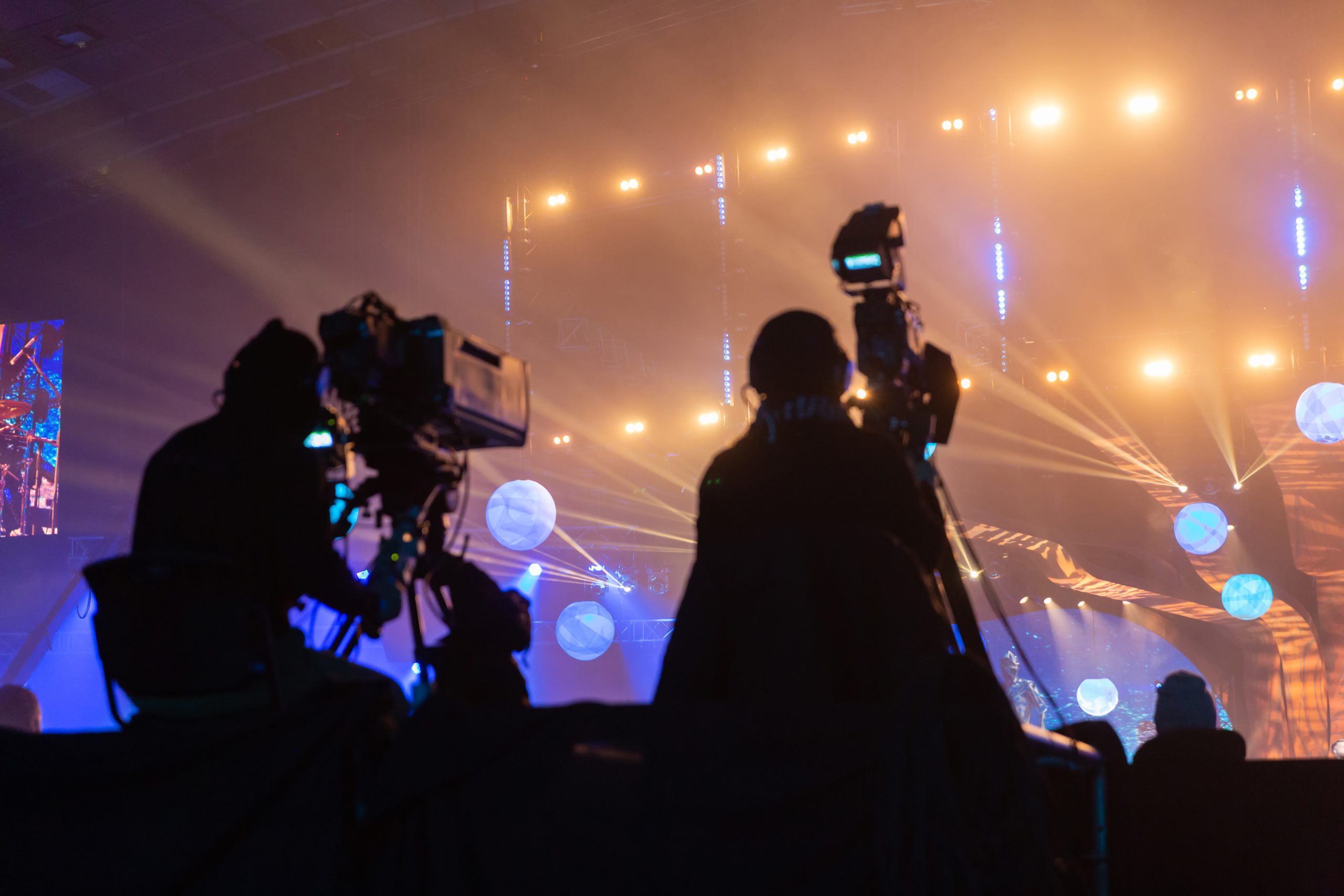 silhouette group cameramen broadcasting event workers are high platform scaled